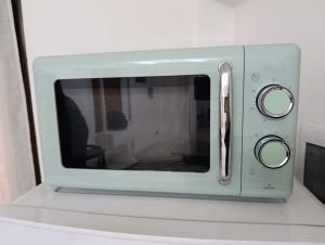 a microwave oven sitting on top of a counter at Palma's house in Cambiago