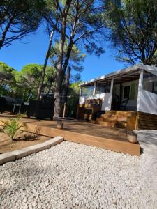 a tiny house with a gazebo at Mobil-home Oasis Village Club in Puget-sur-Argens