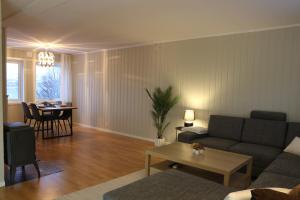 a living room with a couch and a table at Cozy House in Tromsø - Near City Center, Ideal for Families & Groups in Tromsø