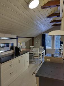 a kitchen with white cabinets and a table at Navy Condo for 6, free parking in Turku
