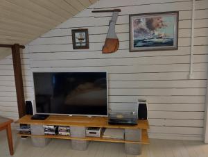 a flat screen tv sitting on top of a table at Navy Condo for 6, free parking in Turku