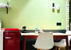 a kitchen with a red refrigerator and a table with a white chair at Mini alloggi alle terme in Abano Terme +7 photos