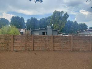 a brick fence in front of a house at Mama R's Budget-friendly BACKROOM 3 in Newcastle