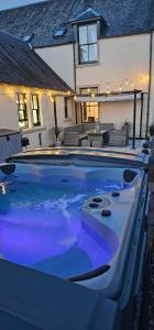 a large swimming pool in front of a house at Antfield House in Inverness