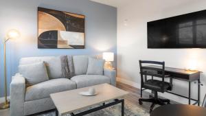a living room with a couch and a table at Landing Apartments - 2720 S Federal in Englewood