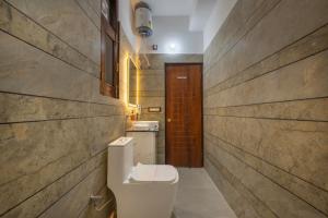 a bathroom with a toilet and a sink at Kasauli Hills Hotel in Kasauli +32 photos