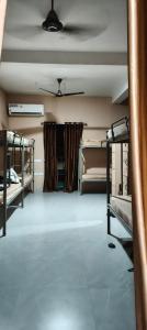 a room with three bunk beds and a ceiling at My own dormitory in Cochin