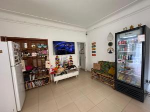 a room with a refrigerator and a couch in it at Hostel Casinha Tropical in Rio de Janeiro