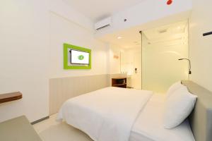 Postel nebo postele na pokoji v ubytování POP! Hotel Pasar Baru Jakarta + 22 fotografií