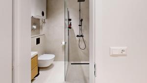 a bathroom with a shower and a toilet at White Lotus Hévíz - 50 m from Thermal Lake in Hévíz +11 photos