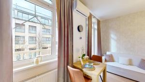 a small apartment with a table and a window at White Lotus Hévíz - 50 m from Thermal Lake in Hévíz