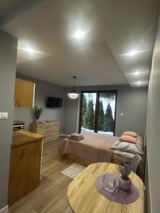a bedroom with a bed and a large window at Pokoje na 6a in Wisła