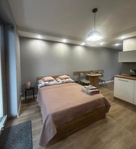 a bedroom with a large bed and a table at Pokoje na 6a in Wisła