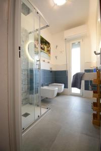 a bathroom with a glass shower and a sink at Fidelica in Stintino +9 photos