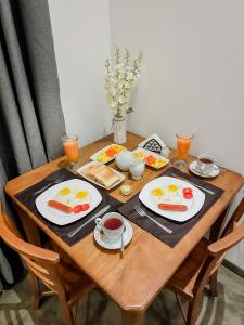 a wooden table with plates of food on it at Lagoon View Mawella Villa in Tangalle