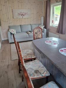 a living room with a table and chairs and a couch at Ferienhaus Solli Norwegen in Kolvereid