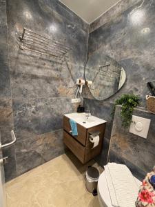 a bathroom with a sink and a mirror at Downtown Apartment in Bonn +69 photos