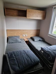 a bedroom with two beds and a window at Lac des rêves in Lattes