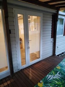 a screened porch with sliding glass doors at Lac des rêves in Lattes +1 photo