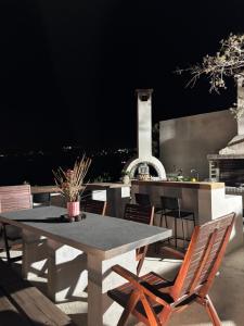 a table and chairs on a patio at night at Cretan stars villas Hersonissos in Hersonissos