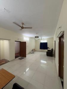 a living room with a ceiling fan and a couch at APK living in Chennai
