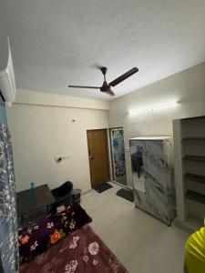 a living room with a ceiling fan and a couch at APK living in Chennai