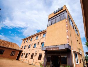 a building with a sign on the side of it at Hulcity silver hotel in Kyebando