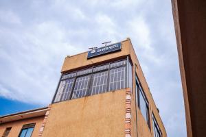 a building with a sign on the top of it at Hulcity silver hotel in Kyebando +8 photos