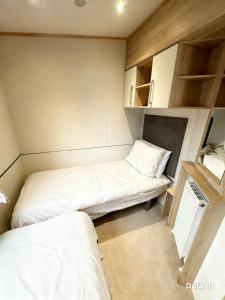 a small room with two beds in it at Church meadow 39 in Pagham
