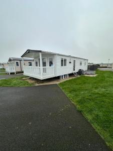 a row of mobile homes parked in a field at Church meadow 39 in Pagham