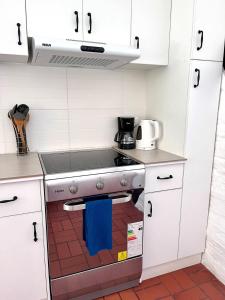 a kitchen with a stove with a blue towel on it at Modern Apartment with Private Balcony in Quito