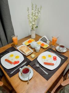 a wooden table with plates of eggs and food at Lagoon View Mawella Villa in Tangalle +58 photos