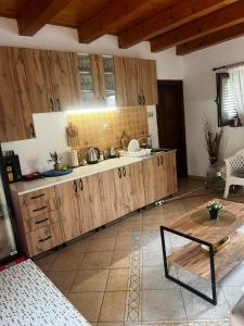 a kitchen with wooden cabinets and a table at Holiday home Raduš in Virpazar