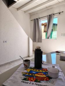 a kitchen counter with a tea kettle on a table at Sol de Caraúbas in Caraúbas