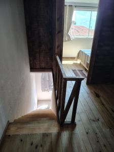 a wooden stair case in a room with a window at Sol de Caraúbas in Caraúbas +5 photos