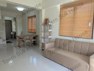 a living room with a couch and a table at เติมสุขเฮาส์ Toem Suk House in Ban Bang Luk