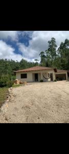 a house with a large driveway in front of it at Sitio4meninos in Pinheiral