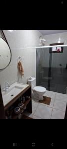 a bathroom with a toilet and a sink and a shower at Sitio4meninos in Pinheiral
