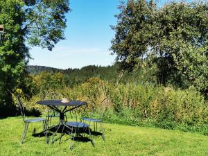 a table and chairs sitting in the grass at Maisonnette cocooning, ancien four à pain in Saint-Éloy-la-Glacière