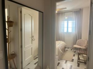 a room with a door leading to a bedroom at Apartamento LH Beach frente al mar in La Herradura +92 photos