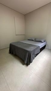 a bedroom with a bed in a white room at Bela Gold Alto Caparaó in Caparaó Velho