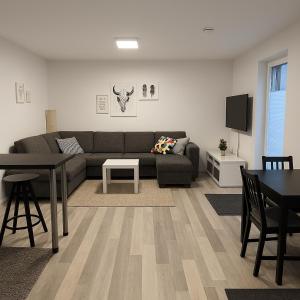a living room with a couch and a table at Apartment Montabaur Heiligenroth in Heiligenroth