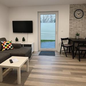 a living room with a couch and a table at Apartment Montabaur Heiligenroth in Heiligenroth