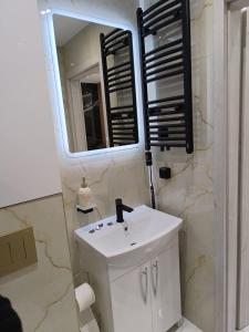 a bathroom with a white sink and a mirror at Blu Apartments -Rynek in Nowa Ruda +30 photos