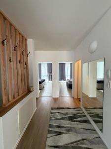 an empty living room with wooden doors and a rug at Ruhige Wohnung in Linz