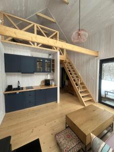 a kitchen with a wooden staircase in a room at Gawra Pogórze in Jawornik Polski