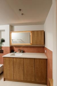 a bathroom with a sink and a mirror at Aélia Studios in Agia Ermioni +28 photos