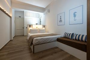 a small bedroom with a bed and a couch at Aélia Studios in Agia Ermioni