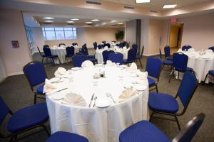a conference room with white tables and blue chairs at Prince Resort in Myrtle Beach +151 photos