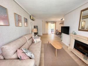 a living room with a couch and a fireplace at Casa Mar in Valencia